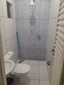 a bathroom with a shower with a toilet and a sink at Pousada Itororó in Bom Jesus da Lapa
