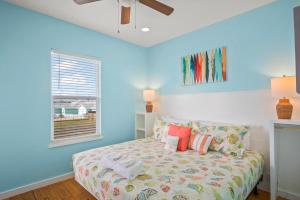 a bedroom with blue walls and a bed with colorful pillows at Eleventh Street in Mustang Beach +38 photos