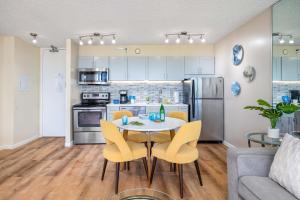 a kitchen and dining room with a table and chairs at 34th floor lanai with Diamond Head views, pool & hot tub access in Honolulu