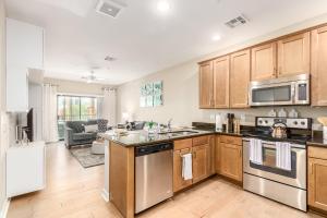 a kitchen with wooden cabinets and stainless steel appliances at Queen Creek #139 Chandler in Chandler