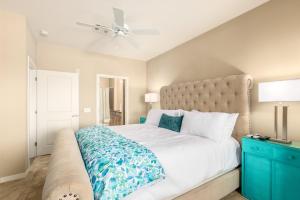 a bedroom with a large bed and a ceiling fan at Queen Creek #139 Chandler in Chandler +18 photos