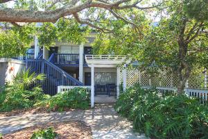 a house with a blue staircase in front of it at Sunsuite - Walk to Beach - Tennis - Olympic Pool in Fripp Island