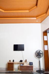 a living room with a flat screen tv on a wall at 2 Bedroom Suite with Sitting Area in Kigali