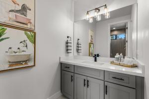 a white bathroom with a sink and a mirror at Cottonrose Flagstaff in Flagstaff +34 photos