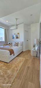 a white bedroom with a bed and a window at Nala Host- Seaside Bliss in Hulhumale +53 photos