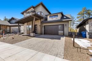 a house with a garage and a driveway at Cottonrose Flagstaff in Flagstaff