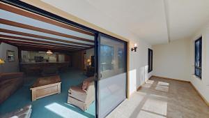 a living room with sliding glass doors and a couch at Retro 3 Bed 3 Bath Condo with Mountain View! Steps to Canyon Lodge! Unit 210 at 1849 in Mammoth Lakes