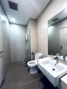 a bathroom with a toilet and a sink and a mirror at Blissful Homes at i-City - WiFi TV Box 1 Carpark in Shah Alam