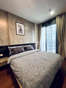 a bedroom with a large bed and a window at Blissful Homes at i-City - WiFi TV Box 1 Carpark in Shah Alam