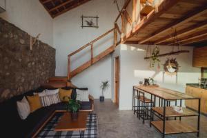 a living room with a couch and a table at Toninas México Bungalow in Celestino Gasca