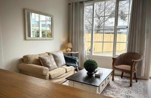 a living room with a couch and a table at The Summer Cottage in Orange