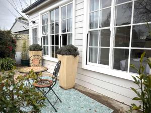 a patio with a table and chairs on a house at The Summer Cottage in Orange