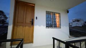 a door on the side of a building with a window at Holtalia in Santiago