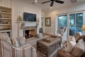 a living room with a fireplace and a tv at 4 Bedroom Wilson Village Home 5036 in Bluffton