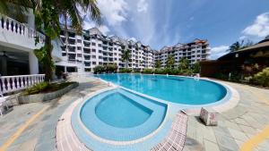 a large swimming pool in front of a building at 10pax GFloor 2R2B DUAL-KEY SEASIDE, WATERSPORT, FREE BBQ Set, Pool, Wifi, 50"TV in Port Dickson