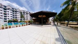 a resort with a pavilion and a swimming pool at 10pax GFloor 2R2B DUAL-KEY SEASIDE, WATERSPORT, FREE BBQ Set, Pool, Wifi, 50"TV in Port Dickson
