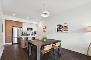 a kitchen and dining room with a wooden table and chairs at Japandi Minimalism | Espadin LoHi in Denver