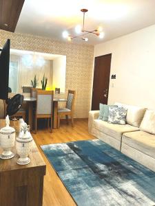 a living room with a couch and a table at Apart Zen Santa Inês in Imperatriz +10 photos