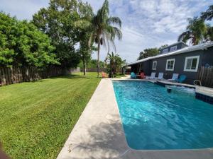 a swimming pool in a yard next to a house at Floridays in Butler Beach