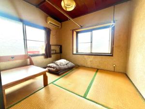 Postel nebo postele na pokoji v ubytování Bridgeブリッジゲストハウス