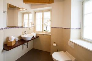 a bathroom with a sink and a toilet at Hotel All'Arco in Trieste