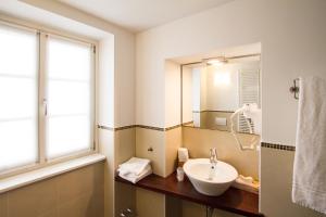 a bathroom with a sink and a mirror at Hotel All'Arco in Trieste