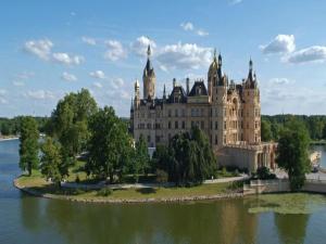 a large building on an island in the water at Chalet in Wendorf, cleaning included in Wendorf