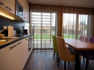 a kitchen with a table and chairs and a large window at Chalet in Wendorf, cleaning included in Wendorf