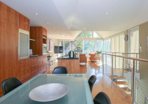 a kitchen and dining room with a table and chairs at The Glass Pinnacle in Bright