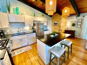a kitchen with white cabinets and a black counter top at Carolina street 210 in Dewey Beach +13 photos