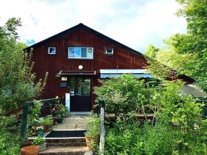 a red barn with a staircase leading to the door at Gallery HARA and guest house in Hara