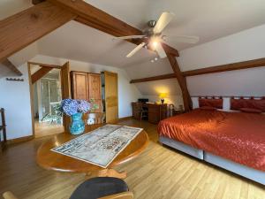 a bedroom with a bed and a table with a vase of flowers at Maison familiale avec piscine privée et animaux admis à Saint-Mesmin - FR-1-839-10 in Saint-Mesmin +27 photos