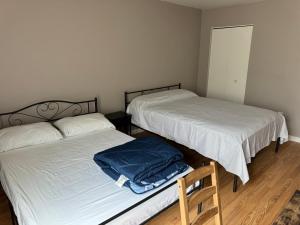 a room with two beds and a chair in it at Near To CCBC ESSEX Private Room 202 in Parkville