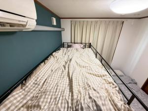 Postel nebo postele na pokoji v ubytování 宿のきむら