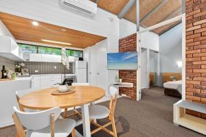 a kitchen and dining room with a table and chairs at Nautilus Resort Apartment 162 Solitary Islands Way 8 in Sapphire Beach