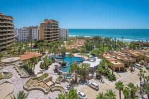 an aerial view of a resort with a pool and the ocean at Bella Sirena in La Choya