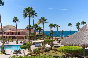 a view of a resort with a swimming pool and palm trees at Marina Pinacate in Puerto Peñasco