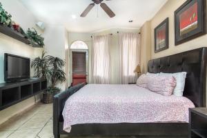 a bedroom with a large bed and a television at Bella Sirena in Puerto Peñasco