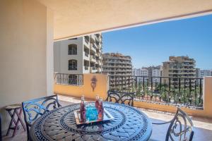 a table on a balcony with a view of a city at Bella Sirena in La Choya