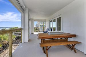 a dining room with a table and a view of the ocean at The White House on Flagler Beach - Unit 23 in Flagler Beach
