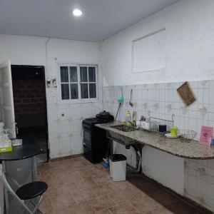 a kitchen with a sink and a stove at hospedaje El Colibrí in La Unión