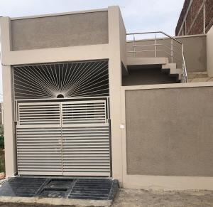 a building with a garage door with a staircase at Garden view homestay fully furnished new in Jabalpur