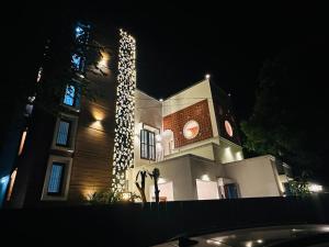 a large building with a clock tower at night at Bamboo Breeze Jaffna in Jaffna