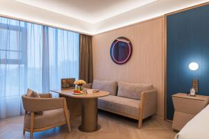 Posezení v ubytování Guangzhou Olympic Sports Centre Financial City Crystal Orange Hotel