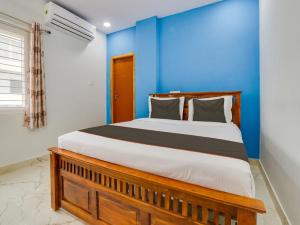 Ένα ή περισσότερα κρεβάτια σε δωμάτιο στο Hotel O SR Grand