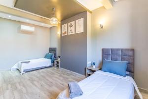two beds in a room with blue and white at Peaceful Marrakech Villa 4 Bedrooms Private Pool in Marrakech