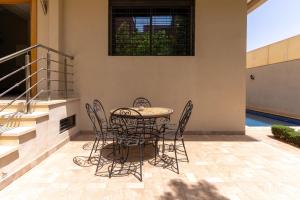 a patio with a table and chairs on a patio at Peaceful Marrakech Villa 4 Bedrooms Private Pool in Marrakech