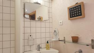 a bathroom with a sink and a mirror at Maison Mimosa in Rodès