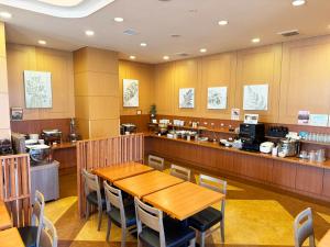a restaurant with a table and chairs and a counter at Route Inn Grantia Shiretoko -Shari Ekimae- in Shari