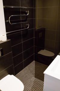 a bathroom with a toilet and a sink at Uus Street 34 Apartment in Kuressaare